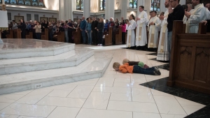 two boys and a dad at ordination in Denver cathedral