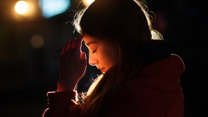 web-woman-praying-night-light-face-tymonko-galyna-shutterstock_404562580